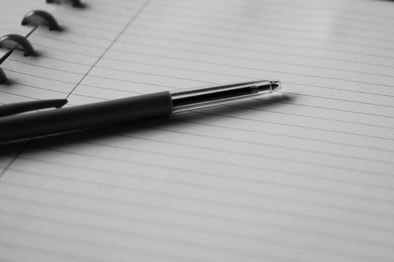 Simple one-page funeral program Open notebook pen